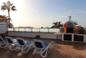 a group of chairs sitting on a roof at ViVa Royal - Immense villa, unique and exclusive in Chayofa