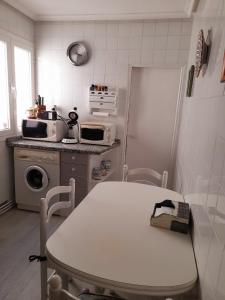 una pequeña cocina con mesa y microondas en La Palomera en León
