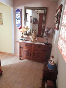 ein Badezimmer mit einem Waschtisch aus Holz und einem Spiegel in der Unterkunft La Palomera in León