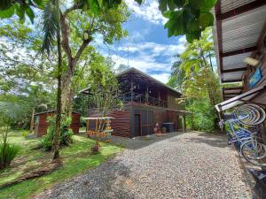 a wooden house with a tree in front of it at Casa Oceana Bed & Breakfast in Bocas Town