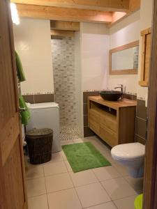 a bathroom with a sink and a toilet and a sink at Gîtes Les Pralets in Saint-Eustache