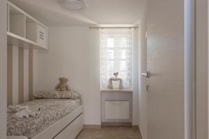 a small bedroom with a bed and a window at Stella Bianca in Savelletri di Fasano