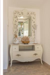 a white dresser with a mirror on top of it at Stella Bianca in Savelletri di Fasano