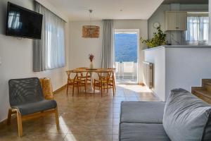 a living room with a couch and a table at Pharos Apartments in Gavrio