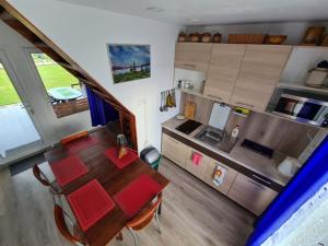 an overhead view of a kitchen and a table in a room at Privati valda in Šventoji