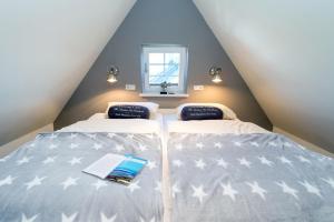a attic bedroom with two beds with stars on them at Sylt Liebe in Wenningstedt