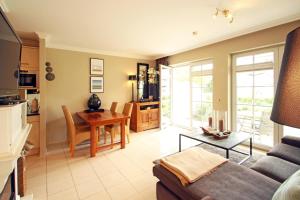 a living room with a couch and a table at Wellnessresidenz Klaus Stoertebeke in Zingst