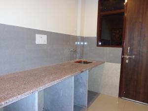 a kitchen with a counter and a sink at Rukmani Inn in Vrindāvan
