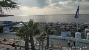 a view of a beach with chairs and the ocean at At Tsyurupy Sochi Apartment in Sochi