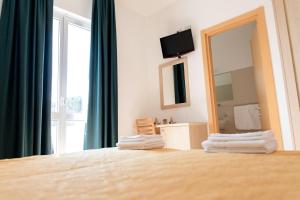 מיטה או מיטות בחדר ב-Hotel Capitano