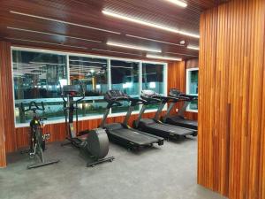 a gym with several treadmills and ellipticals in a building at APTO SALINAS EXCLUSIVE RESORT - 04 Hóspedes Adultos e 01 Criança até 03 anos in Salinópolis