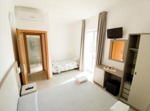 Postel nebo postele na pokoji v ubytování Hotel Capitano