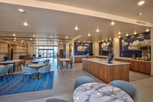 a lobby of a hotel with tables and chairs at Scenic View Inn & Suites Moab in Moab