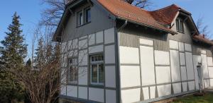 a white and black house with a red roof at Fliederhaus Dresden in Dresden