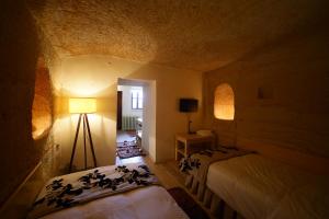 Postel nebo postele na pokoji v ubytování 4 Oda Cave House - Special Class