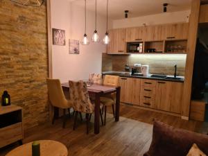 a kitchen with a table and chairs in a room at Hedonic in Kopaonik