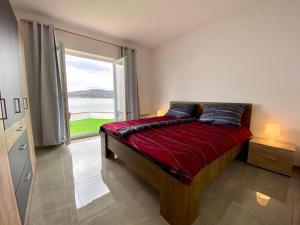 a bedroom with a bed with a large window at Villa Olga - Uniqe house with private beach in Ankaran