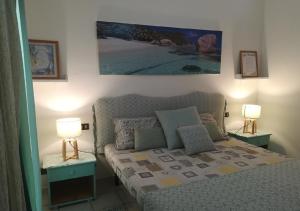 a small bedroom with a bed and two lamps at Sea view houses, Praia de Chaves, Boa Vista, Cape Verde, FREE WI-FI in Cabeçadas