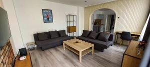 a living room with a couch and a table at Apartament Grunwaldzka in Tuchola