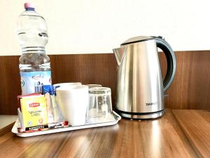 a tea kettle and a bottle of water on a table at Hotel Pod Jeleniem in Sobótka