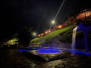 a group of blue lights in a waterfall at night at Rancho San Antonio in Salento