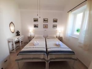 a bedroom with a large bed with towels on it at Dapia Holiday Home in Spetses