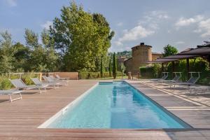 a swimming pool with lounge chairs and a house at Château Des Ducs De Joyeuse in Couiza