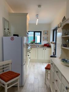 a kitchen with a white refrigerator and a table at Avoca Farm in Holywood