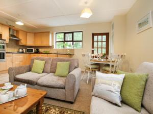 a living room with a couch and a table at Bryn Eira Tack Room in Llanfairpwllgwyngyll