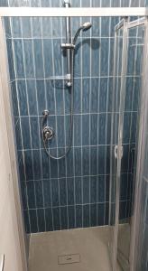 a blue tiled shower with a shower head at B&B Castelluccio in Villafranca Tirrena