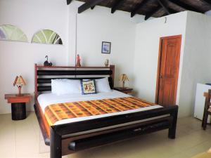 a bedroom with a large bed in a room at Hotel Puerto Gaviota in Tonsupa