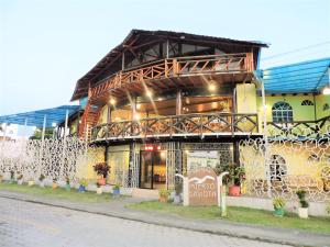 a building with a sign in front of it at Hotel Puerto Gaviota in Tonsupa