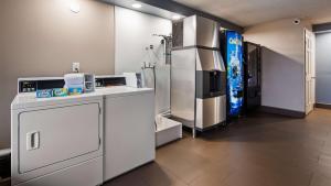 a kitchen with a refrigerator and a stove at SureStay Hotel by Best Western Jasper in Jasper
