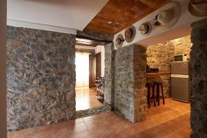 a room with stone walls and a kitchen with a refrigerator at Ga281 in Funchal