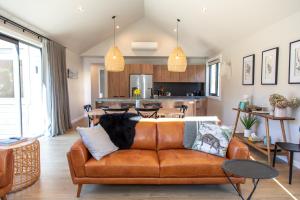 a living room with a couch and a kitchen at New Arrowtown Home, Complete comfort in Arrowtown +8 photos