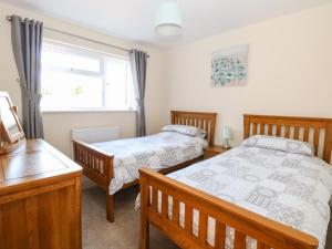a bedroom with two beds and a window at Elliott's Retreat in Sheringham