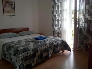 a bedroom with a bed and a large window at Villa Jadranka in Hvar