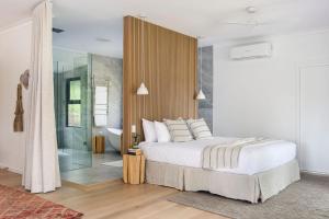 a bedroom with a bed and a glass shower at Cedars Mount View (Adults Only) in Mount View