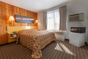 מיטה או מיטות בחדר ב-Starlight Lodge