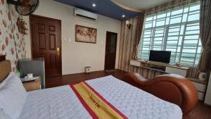 ein Schlafzimmer mit einem Bett und einem TV in der Unterkunft Sky Hotel in Biên Hòa