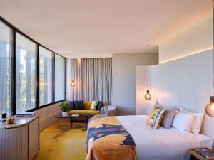 a hotel room with a bed and a couch at Crystalbrook Kingsley in Newcastle