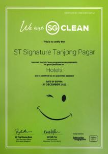 a green sign with a smiley face on it at ST Signature Tanjong Pagar in Singapore