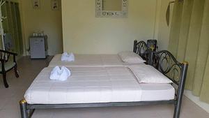 a bed with two white towels on top of it at ไอหมอก ชาเล่ต์ in Wang Nam Khieo