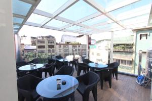 a restaurant with tables and chairs on a balcony at Sea Keelung in Keelung