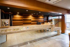 a lobby with a front desk in a building at Kanazawa Central Hotel in Kanazawa