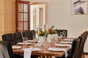 a dining room table with chairs and a table cloth at Eight Willows Retreat in Margaret River Town