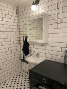 a white bathroom with a sink and a mirror at NO:4 in Vaasa