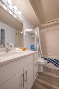 łazienka z umywalką, toaletą i lustrem w obiekcie Luxurious One Bedroom Suite for a Larger Family 162 w mieście Canmore