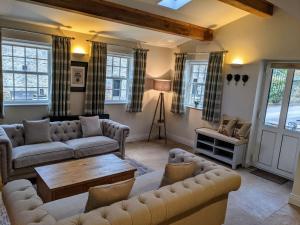 a living room with couches and a table at The Saddle Room in Middleham