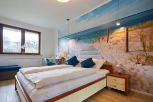 sypialnia z łóżkiem i obrazem plaży w obiekcie Apartamenty Świnoujście - Apartament kapitański Rezydencja Żeromskiego w Świnoujściu